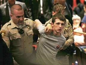 In this June 18, 2016 file photo, police remove Michael Steven Sandford as Republican presidential candidate Donald Trump speaks at the Treasure Island hotel and casino in Las Vegas.