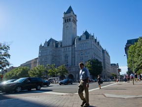 n this Monday, Sept. 12, 2016, file photo, pedestrians cross Pennsylvania Avenue across the street from the Trump International Hotel in downtown Washington.