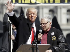 Donald Trump, left, is joined by Carl Paladino during a 2014 gun rights rally at the Empire State Plaza in Albany, N.Y. Paladino, who co-chaired Trump's state campaign, confirmed to that he told a New York alternative newspaper he hoped President Barack Obama would die from mad cow disease.