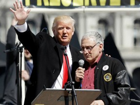 In this April 1, 2014 photo, Donald Trump, left, is joined by Carl Paladino during a gun rights rally at the Empire State Plaza in Albany, N.Y. Paladino, who co-chaired president-Elect Donald Trump’s state campaign, confirmed to The Associated Press on Friday, Dec. 23, 2016 that he told a New York alternative newspaper he hoped President Barack Obama would die from mad cow disease and that the first lady would “return to being a male.”