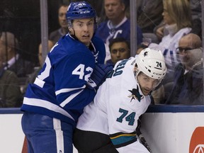Toronto Maple Leafs centre Tyler Bozak (left) battles San Jose Sharks defenceman Dylan DeMelo on Dec. 13.