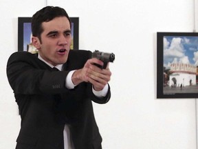A gunman in a suit and tie shouted slogans about Syria's civil war after he killed Russia's ambassador to Turkey in front of stunned onlookers at a photo exhibition
