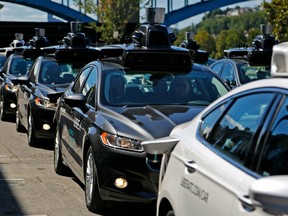 A group of self driving Uber vehicles position themselves to take journalists on rides during a media preview at Uber's Advanced Technologies Center in Pittsburgh, Monday, Sept. 12, 2016.