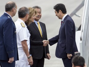 Caroline Kennedy, U.S. Ambassador to Japan, third from left, greets Japan's Prime Minister Shinzo Abe at Joint Base Pearl Harbor Hickam, Monday, Dec. 26, 2016