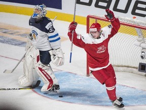 Denmark's Frederik Hoeg celebrates a goal by teammate David Madsen against Finland goaltender Veini Vehvilainnen during first-period of Tuesday's world junior championship game in Montreal.