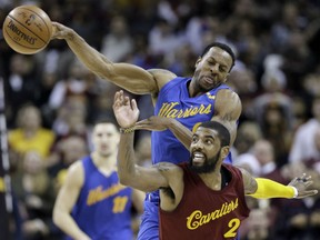 Kyrie Irving of the Cavaliers and Golden State Warriors' Andre Iguodala battle for a loose ball in the second half of  theirl game Sunday night in Cleveland. The Cavaliers won 109-108.