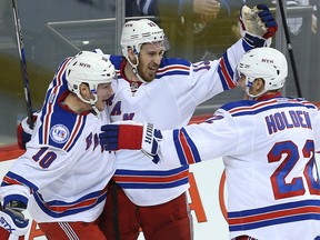 Kevin Hayes, centre, celebrates his game winning goal against the Winnipeg Jets with New York teammates J.T. Miller, left, and Nick Holden during their game Thursday night in Winnipeg. The Rangers won 2-1.