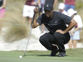 Tiger Woods lines up a putt on the first hole during the first round at the Hero World Challenge golf tournament in Nassau, Bahamas on Dec. 1.