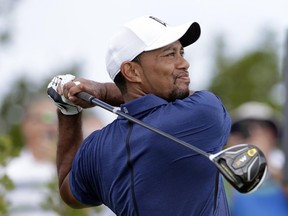 Tiger Woods watches his tee shot on the first hole during the second round at the Hero World Challenge golf tournament on Friday, Dec. 2, 2016, in Nassau, Bahamas.