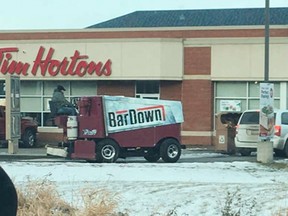 A man drives a Zamboni through a Tim Hortons take-out window in Stony Plain, Alta. in this undated Instagram handout photo.