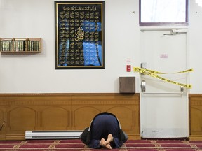 A Muslim man prays at the Centre Islamique Badr in Montreal, Thursday, January 19. A recent court judgement found a move to ban the religious centre on zoning grounds violated members' constitutional rights.