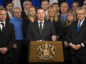 Economic Development Minister Deron Bilous along with representatives of 18 businesses and groups speak on the results of a November trade mission to China and Japan at the Alberta legislature, in Edmonton on Friday Dec. 9, 2016.