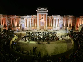 People attend a music concert in the ancient theatre of Syria's ravaged Palmyra on May 6, 2016 following its recapture by regime forces from the Islamic State group fighter.
Syrian troops backed by Russian air strikes and special forces on the ground recaptured UNESCO world heritage site Palmyra from Islamic State (IS) group fighters in March 2016.