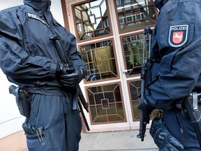 Policemen secure an entrance to the Higher Regional Court in Celle near Hanover, northern Germany, where a verdict was expected against suspected jihadist girl Safia S