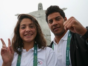 Olympic Refugee Team swimmers Yusra Mardini (left) and Rami Anis pose for a photo in front of the Christ the Redeemer statue in Rio on July 30. A group of 10 athletes from South Sudan, Syria, Congo and Ethiopia competed at Rio 2016 under the Olympic flag.