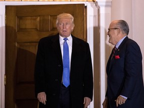 President-elect Donald Trump and former New York City mayor Rudy Giuliani exit the clubhouse following their meeting at Trump International Golf Club, November 20, 2016 in Bedminster Township, New Jersey. Trump and his transition team are in the process of filling cabinet and other high level positions for the new administration.