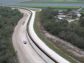 A U.S. Border Patrol vehicle drives next to a fence at the U.S.-Mexico border on January 5, 2017 near McAllen, Texas.