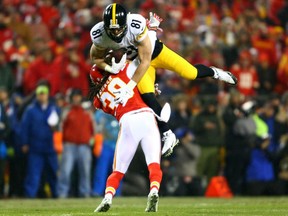 Free safety Ron Parker of the Kansas City Chiefs tackles tight end Jesse James of the Pittsburgh Steelers after a catch for a first down in the first quarter of the AFC Divisional Playoff game at Arrowhead Stadium on Sunday in Kansas City, Missouri.