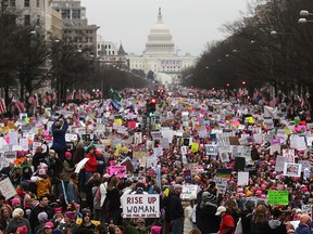 Protesters walk during the Women’s March on Washington, with the U.S. Capitol in the background, on January 21, 2017 in Washington, DC. Large crowds are attending the anti-Trump rally a day after U.S. President Donald Trump was sworn in as the 45th U.S. president