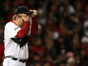 Former Boston Red Sox pitcher Curt Schilling wipes his brow during Game 2 of the 2007 World Series on Oct. 25, 2007.