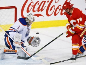 Flames forward Micheal Ferland looks to catch a rebound as Edmonton Oilers goaltender Laurent Brossoit stops this shot in the third period of game at the Scotiabank Saddledome in Calgary on Saturday.