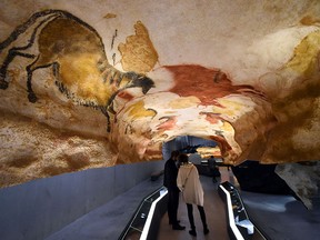 People visit the new replica of the Lascaux cave paintings during the first public opening on December 15, 2016 in Montignac, in the Dordogne region of southwest France, more than seven decades after the prehistoric art was first discovered.