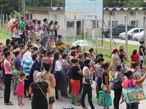 Relatives of inmates ask for information at the main gate of the Anisio Jobim Penitentiary Complex after a riot left at least 60 people killed and several injured, in Manaus, Amazonia state, Brazil.