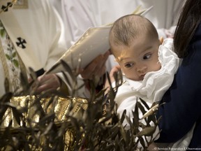 This handout picture released by the Vatican press office shows Pope Francis celebrating baptisms on January 8, 2017 at the Sistine Chapel in Vatican. Pope Francis encouraged women to feel free to breastfeed their children in the church.