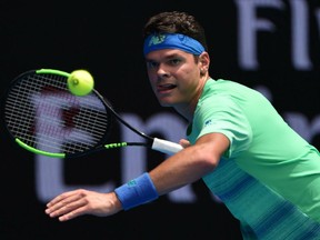 Milos Raonic hits a shot against Dustin Brown of Germany during their men's singles match on day two of the Australian Open in Melbourne.