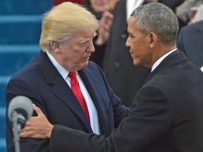 Barack Obama greets Donald Trump as he arrives on the platform at the US Capitol in Washington, DC, on January 20, 2017