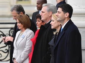 Paul Ryan, front, watches as former President Barack Obama and Michelle Obama depart after the 2017 Presidential Inauguration at the US Capitol.