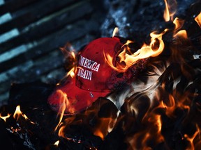 A 'Make America Great Again' hat on fire in Washington, DC, on January 20, 2017