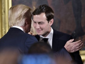 Donald Trump congratulates his son-in-law and senior advisor Jared Kushner after the swearing-in of senior staff in the East Room of the White House on January 22, 2017