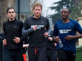 Prince Harry jogs with staff and participants of a running oriented program for homeless and vulnerable young people in northwest London on Thursday.