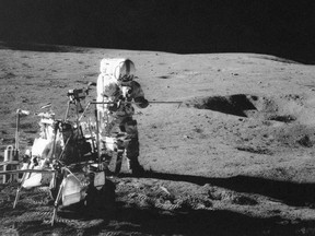 In this Feb. 13, 1971 file photo, Apollo 14 astronaut Alan B. Shepard Jr. conducts an experiment near a lunar crater, using an instrument from a two-wheeled cart carrying various tools. On Wednesday, Jan. 11, 2017, a California-led research team reported that the moon formed within 60 million years of the birth of the solar system. Previous estimates ranged within 100 million years, all the way out to 200 million years of the solar system's creation.