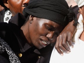 Akon Guode  at the funeral for her three children Bol, Hanger and Madit at St Andrews Catholic Church on April 18, 2015 in Melbourne, Australia. Guode has pleaded guilty to drowning her three children.