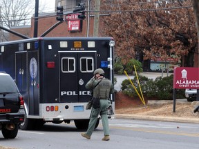 Law enforcement surround the Alabama Credit Union on reports of a hostage standoff in Tuscaloosa, Ala., Tuesday, Jan. 10, 2017.