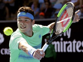 Canada's Milos Raonic makes a backhand return to Luxembourg's Gilles Muller during their second round match at the Australian Open tennis championships in Melbourne, Australia, Thursday.
