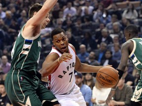 Kyle Lowry of the Raptors drives past the defence of Milwaukee Bucks guard Matthew Dellavedova during first half NBA action in Toronto on Friday night.