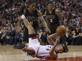 Toronto Raptors' Cory Joseph tries to play a pass as he goes to the floor at the feet of Phoenix Suns' Brandon Knight in Toronto on Sunday.