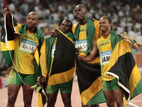 Usain Bolt, second from right, Michael Frater, right, Asafa Powell, left, and Nesta Carter celebrate after the men's 4x100-metre relay final during the Beijing 2008 Olympics.