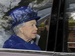 Britain's Queen Elizabeth II in a car with Prince Philip, arrives to attend the morning church service at St Mary Magdalene Church in Sandringham, England, Sunday Jan. 8. It was her first public appearance in several weeks.