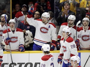 Montreal Canadiens defenceman Shea Weber, centre acknowledges the applause as a tribute to him is played on the scoreboard during the first period of their game against the Predators on Tuesday night in Nashville, Tenn.