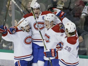 Max Pacioretty, second from left, jumps to celebrate scoring the game winning goal with teammates Phillip Danault (24), Michael McCarron (34) and Jeff Petry (26) during overtime against the Stars in Dallas on Wednesday night. The Canadiens won 4-3.