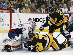 Pittsburgh Penguins' Evgeni Malkin gets the puck past Washington Capitals goalie Philipp Grubauer for his third goal of the game in Pittsburgh on Monday.