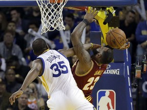 Golden State Warriors' Kevin Durant blocks the shot of Cleveland Cavaliers' LeBron James, right, during the second half Monday in Oakland.