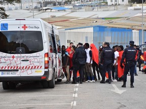 Migrants queue to board a Red Cross bus in El Tarajal, Ceuta, close to the boarder with Morocco on Dec. 9, 2016 after being rounded up by police to be attended to by Red Cross personnel and taken to the Center for Temporary Stay of Immigrants (CETI) after nearly 400 migrants forced their way through a fence between Morocco and the tiny Spanish enclave of Ceuta. Another 1,100 migrants tried to cross the border on Sunday.