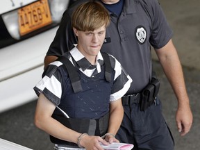 Charleston, S.C., shooting suspect Dylann Roof is escorted from the Cleveland County Courthouse in Shelby, N.C. on June 18, 2015.