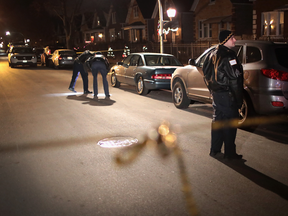 Police investigate the scene of a shooting where a 23-year-old woman was shot in the chest and hand and a 25-year-old man was shot in the leg on Jan. 1, 2017 in Chicago, Illinois.