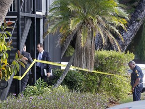 Clearwater Police detectives and an officer stand outside the ground floor apartment where a 10-year-old boy was fatally shot in his home on Thursday morning, Jan. 5, 2017